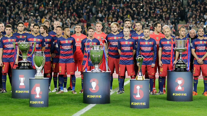 FC Barcelona players pose with the five trophies the team won in 2015 before their last match of the year, a Spanish La Liga soccer match against Betis, at the Camp Nou stadium in Barcelona, Spain, Wednesday, Dec. 30, 2015. (AP Photo/Emilio Morenatti)